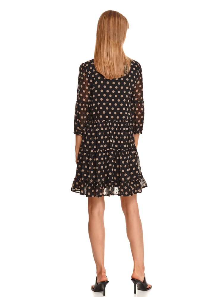 Sukienka w grochy z wiązaniem pod szyją i falbaną