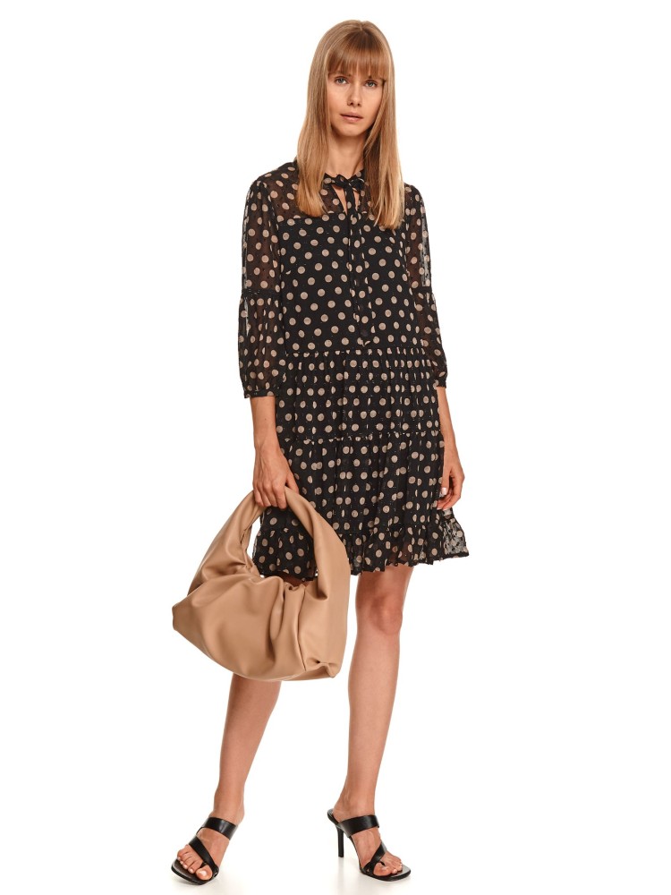 Sukienka w grochy z wiązaniem pod szyją i falbaną